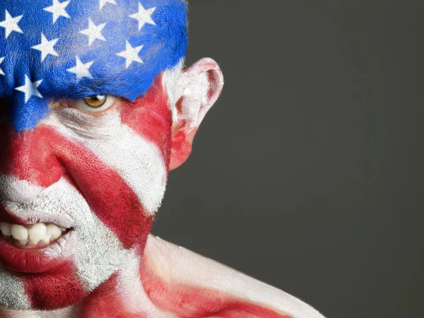 Mann mit einem Gesicht, das mit der Flagge der USA bemalt ist, aggressiv — Stockfoto