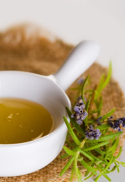 Golden honey with herbs — Stock Photo, Image