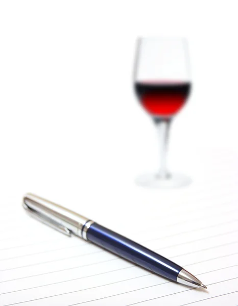 Bolígrafo con copa de vino sobre papel forrado — Foto de Stock