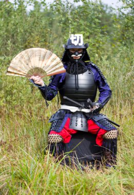 Samurai in armor with fan clipart