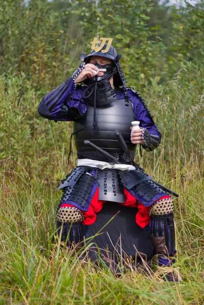 stock image Samurai in armor drinking sake from cup