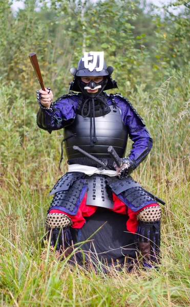 stock image Samurai in armor showing direction by folded fan