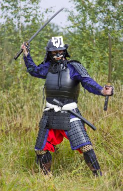 Samurai in armor with two swords clipart
