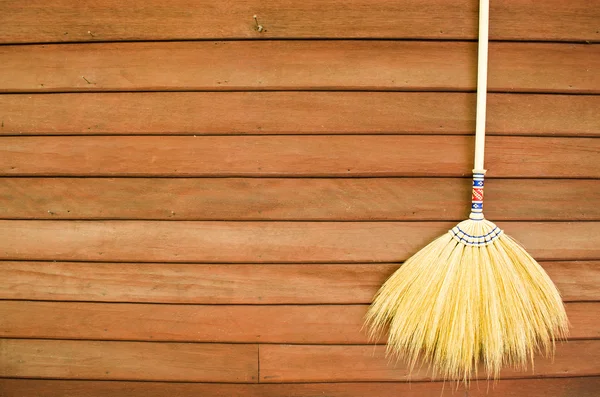 Broom on wooden wall — Stock Photo, Image