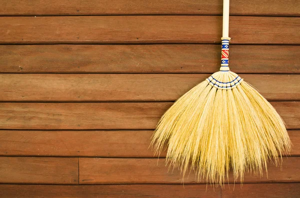Broom on wooden wall — Stock Photo, Image