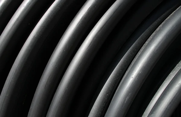 Black plastic tubes — Stock Photo, Image