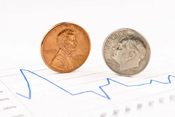 Penny and dime coins standing on chart — Stock Photo, Image