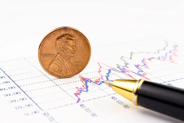 Penny coin with pen standing on chart — Stock Photo, Image