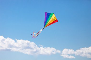 Colorful kite flying in the wind clipart