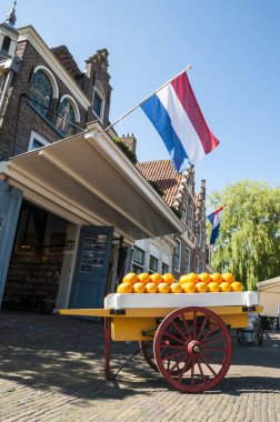 EDAM, HOLLAND - MAY 28: The famous cheese market of Edam, with l clipart