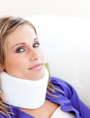 Young woman with a neck brace looking in the camera clipart