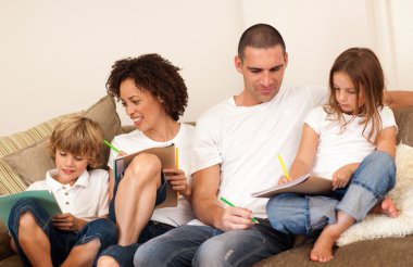 Family drawing togethe on the couch clipart