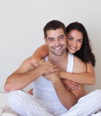 Smiling beautiful girl hugging her attractive boyfriend clipart