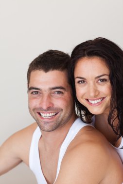 Positive young couple sitting on the bed clipart