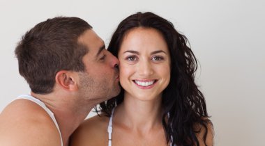 Young man kissing his girlfriend clipart