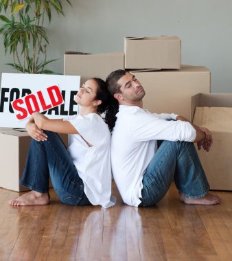 Happy young couple moving house clipart