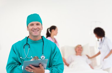 Cofident doctor with his team in the background clipart