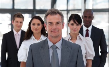 Portrait of a confident business team looking at the camera clipart