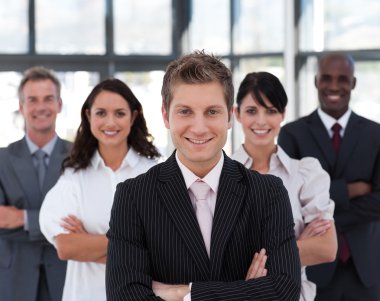 Happy business team looking at the camera clipart