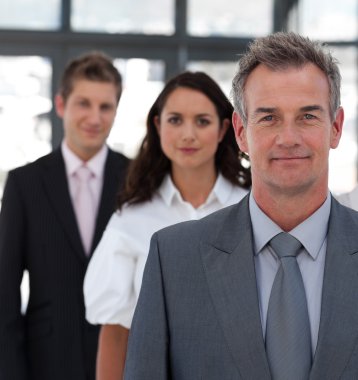 Portrait of a self-assured business team looking at the camera clipart