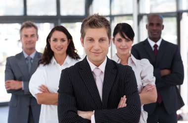 Confident business team looking at the camera clipart