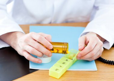 Close-up of a doctor giving pills to a patient clipart