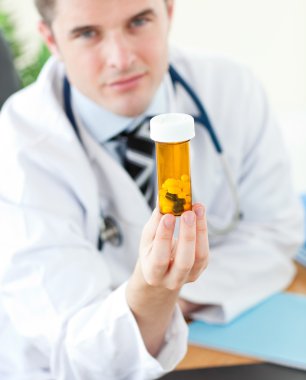 Doctor holding pills clipart