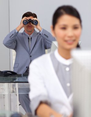 Visionary businessman using binoculars clipart