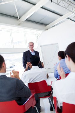 Business applauding the speaker after the conference clipart