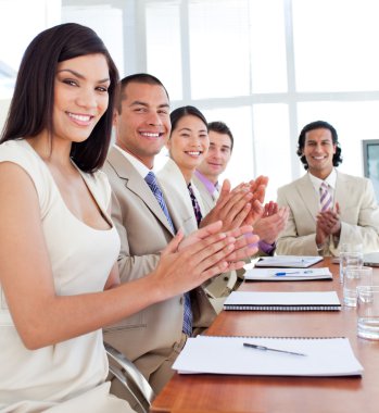 Multi-ethnic business team applauding after a conference clipart