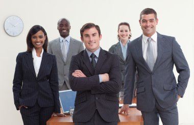 Confident business team standing in a meeting and smiling clipart