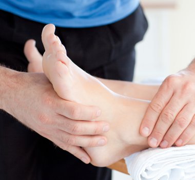 Close-up of a woman enjoying a foot massage clipart