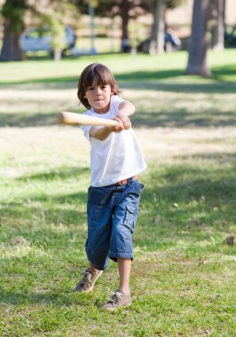 Lively little boy playing baseball clipart