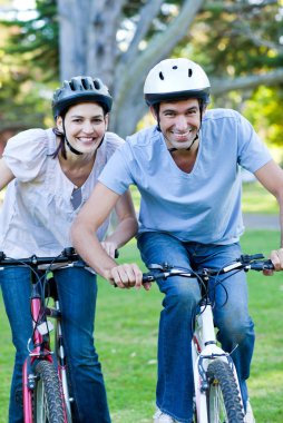 Animated couple riding a bike clipart