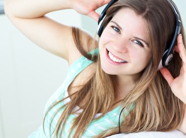 Charming girl listening to music clipart