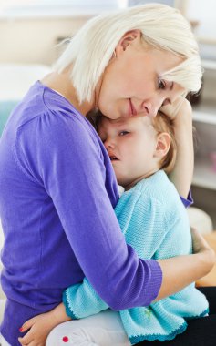 Blond woman taking care of her child clipart