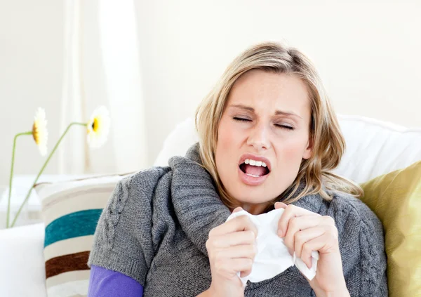 Young woman sneezes — Stock Photo, Image