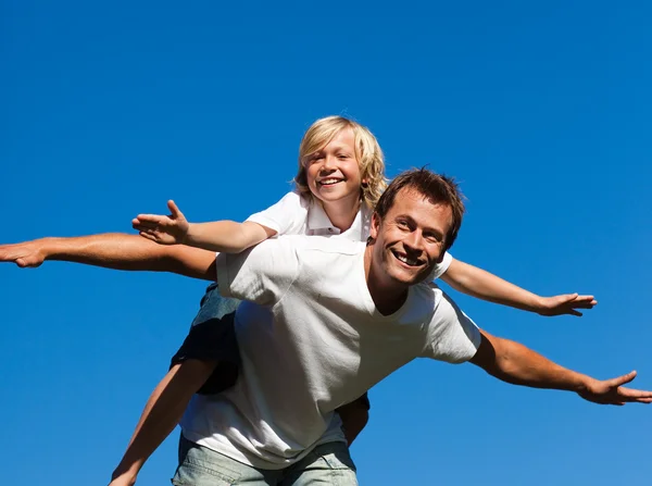 Happy father with his son on his back outdoor — Stock Photo, Image