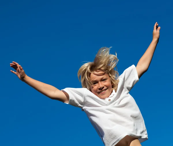 Smiling Kid Jumping in the air outdoor — Stock Photo, Image