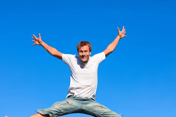 Portrait of a smiling Man jumping in the air outdoor — Stock Photo, Image