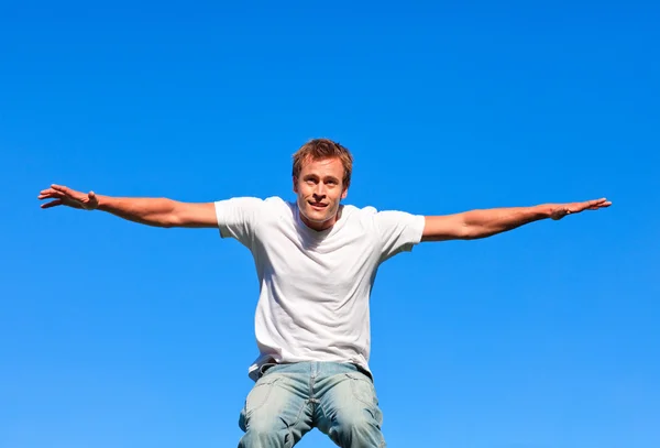 Portrait of a positive Man jumping in the air outdoor — Stock Photo, Image