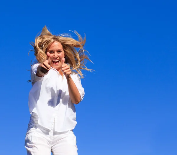 stock image Portrait of an radiant woman jumping in the air outdoor