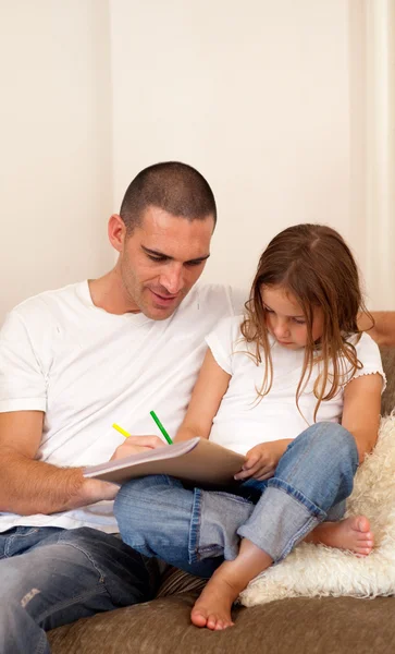 Father and daughter sitting on the couch — Stock Photo, Image