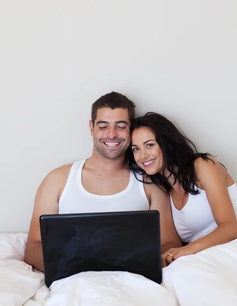 Jolly couple lying in the bed — Stock Photo, Image