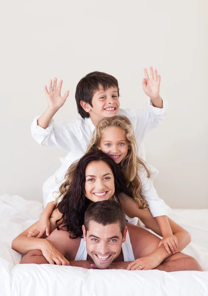 Smiling boy with hands up with his family — Stock Photo, Image