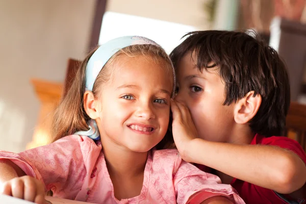 Boy whisper in the ear of his sister — Stock Photo, Image