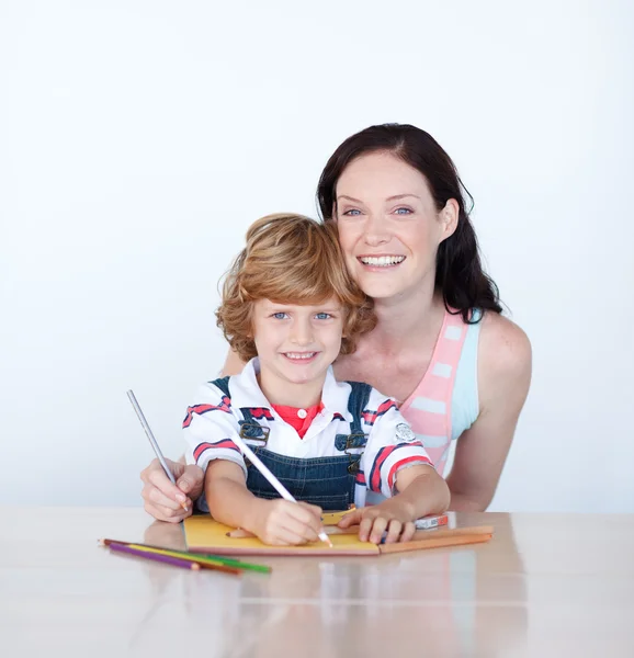 Mother and son writing at home — Stock Photo, Image