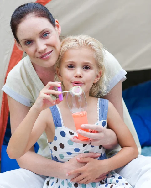 Fiatal anya és a sátor előtt imádnivaló gyermek — Stock Fotó