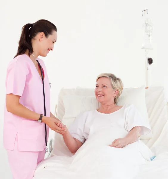 Mooie lachende verpleegster helpen een hogere patiënt — Stockfoto