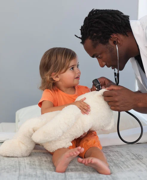 Kinderarzt im Gespräch mit einem kleinen Mädchen — Stockfoto